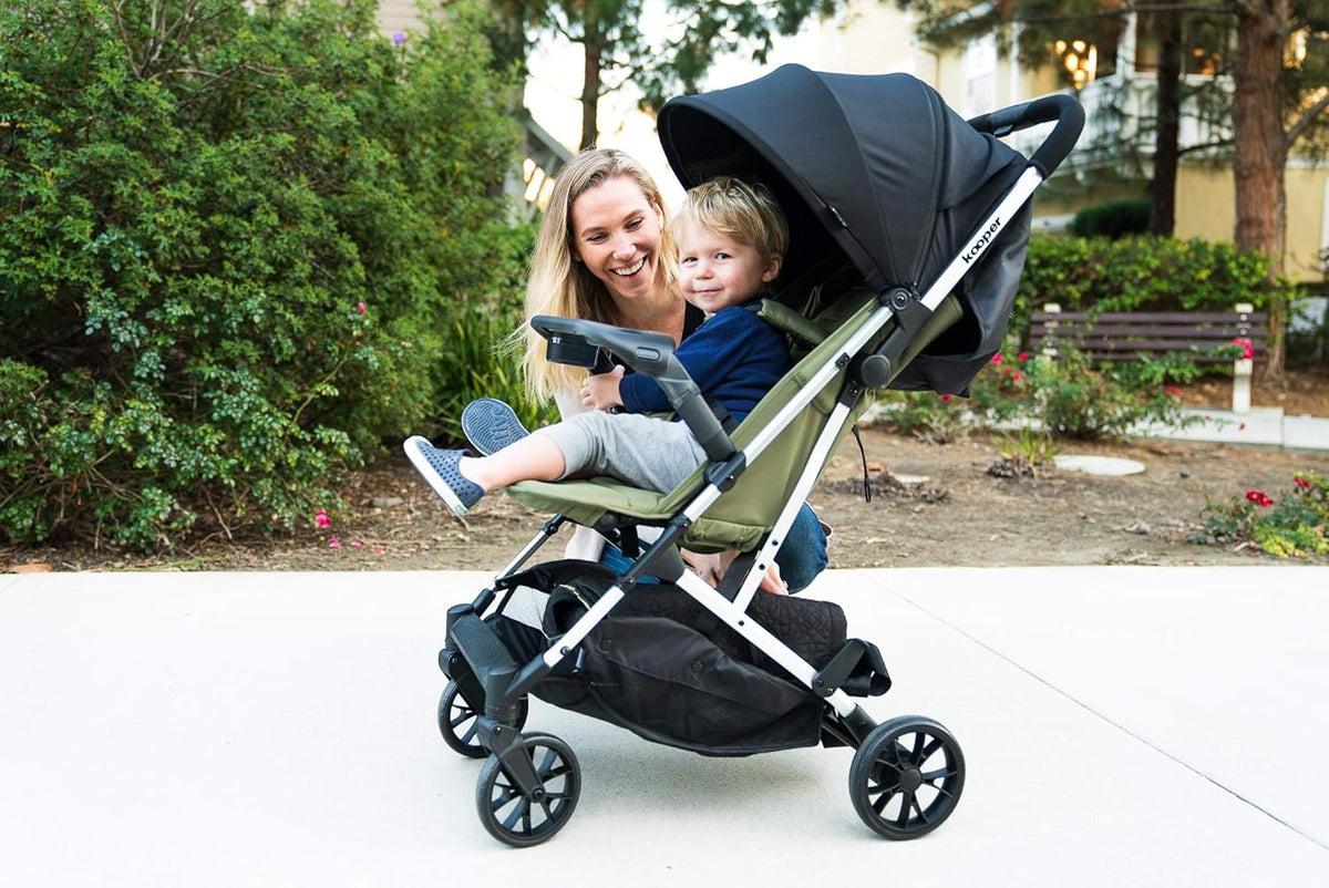 Joovy Kooper Lightweight Baby Stroller Featuring Removable, Swing-Open Tray, Big Wheels, Reclining Seat with Footrest, Extra-Large Retractable Canopy, and Compact Fold (Olive)